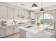 Modern kitchen with island, stainless steel appliances, and backyard access at 6412 N 17Th Pl, Phoenix, AZ 85016