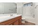 Clean bathroom with tub, shower, and wood vanity at 10112 S 185Th Dr, Goodyear, AZ 85338