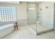 Bathroom with large walk-in shower, freestanding tub and glass block window at 2662 N Chestnut Cir, Mesa, AZ 85213