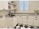 Well-appointed laundry room with ample counter space and stylish finishes at 2662 N Chestnut Cir, Mesa, AZ 85213