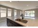 Modern kitchen with quartz countertops, stainless steel appliances, and an island at 243 E Citrus Hollow Way, Queen Creek, AZ 85140