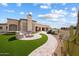 Landscaped backyard featuring a fire pit and curved walkway at 10270 E Saddle Horn E Trl, Scottsdale, AZ 85255