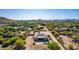 Aerial view of a house with a pool and large backyard, surrounded by desert landscaping at 39004 N 33Rd Ave, Phoenix, AZ 85086