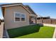 House exterior showcasing a light brown color scheme and a grassy backyard at 23142 E Thornton Rd, Queen Creek, AZ 85142