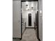 Modern galley kitchen with white cabinets and gray tile at 3119 W Cochise Dr # 225, Phoenix, AZ 85051
