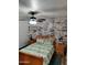 Sleigh bed in bedroom with whitewashed brick feature wall at 3119 W Cochise Dr # 225, Phoenix, AZ 85051