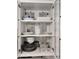 White kitchen cabinet filled with dishes at 3119 W Cochise Dr # 225, Phoenix, AZ 85051