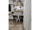 Living Room workspace with white metal chair and brick accent wall at 3119 W Cochise Dr # 225, Phoenix, AZ 85051
