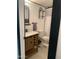 Updated bathroom with a wood vanity, white tile, and a shower/tub at 3119 W Cochise Dr # 225, Phoenix, AZ 85051