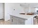 White kitchen island with quartz countertop and modern hardware at 10763 W Beatrice St, Avondale, AZ 85323