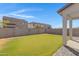 Spacious backyard with grassy lawn and block wall for privacy at 10763 W Beatrice St, Avondale, AZ 85323