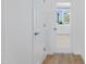 Bright hallway with wood-look floors and a glass-paned door at 10763 W Beatrice St, Avondale, AZ 85323