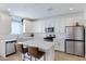 Modern kitchen featuring white cabinets, stainless steel appliances, and an island at 10763 W Beatrice St, Avondale, AZ 85323