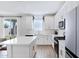 Modern kitchen with white cabinets, island, and view of backyard at 10763 W Beatrice St, Avondale, AZ 85323