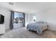 Bright bedroom with large window, gray carpet, and a comfortable-looking bed at 10763 W Beatrice St, Avondale, AZ 85323