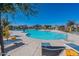 Community pool with lounge chairs and umbrellas at 10763 W Beatrice St, Avondale, AZ 85323