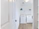 Bright laundry room with washer, dryer, and additional shelving at 10763 W Beatrice St, Avondale, AZ 85323