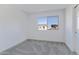 Simple bedroom with a large window and gray carpeting at 10763 W Beatrice St, Avondale, AZ 85323