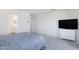 Spacious bedroom with ensuite bathroom access and a wall-mounted TV at 10763 W Beatrice St, Avondale, AZ 85323