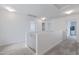 Upstairs hallway with carpet, doors to bedrooms, and a railing at 10763 W Beatrice St, Avondale, AZ 85323