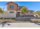 Two-story home with brick and siding exterior, landscaping, and a two-car garage at 10763 W Beatrice St, Avondale, AZ 85323