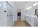 Modern bathroom with double vanity, large walk-in shower, and linen closet at 10763 W Beatrice St, Avondale, AZ 85323