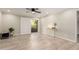 Serene bedroom with wood-look tile floors, a balcony, and a gold console table at 12212 N Paradise Village S Pkwy # 343, Phoenix, AZ 85032