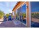 Backyard patio access with grill and seating at 42086 W Solitare Dr, Maricopa, AZ 85138