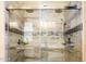 Large walk-in shower with glass enclosure and tile at 42086 W Solitare Dr, Maricopa, AZ 85138