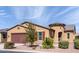 Tan two-story house with a two-car garage at 42086 W Solitare Dr, Maricopa, AZ 85138