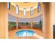 Relaxing hot tub with scenic mural in a round room at 42086 W Solitare Dr, Maricopa, AZ 85138