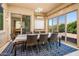 Bright sunroom with dining table and access to backyard at 42086 W Solitare Dr, Maricopa, AZ 85138