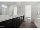 Bright bathroom boasts double sinks and dark brown cabinetry at 17279 W Dartmouth St, Surprise, AZ 85388