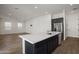 Modern kitchen island with white countertop and dark cabinetry at 17279 W Dartmouth St, Surprise, AZ 85388