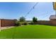 Landscaped backyard oasis with artificial turf at 17425 W Willow Ave, Surprise, AZ 85388