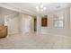 Bright dining room with tile floors, chandelier, and barn door accent at 17425 W Willow Ave, Surprise, AZ 85388