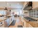 Spacious kitchen with an island, stainless steel appliances, and white shaker cabinets at 18226 W Desert Willow Dr, Goodyear, AZ 85338