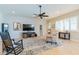 Spacious living room with a large TV, comfortable seating, and a ceiling fan at 18226 W Desert Willow Dr, Goodyear, AZ 85338