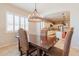 Elegant dining room with a large wooden table and chandelier at 18226 W Desert Willow Dr, Goodyear, AZ 85338