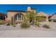 Single-story home with arched entryway,desert landscaping, and a two-car garage at 18226 W Desert Willow Dr, Goodyear, AZ 85338