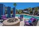 Relaxing fire pit with comfortable seating around the pool at 18226 W Desert Willow Dr, Goodyear, AZ 85338