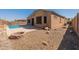 Landscaped backyard with a fire pit and gravel at 18226 W Desert Willow Dr, Goodyear, AZ 85338