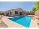 Inviting backyard oasis with a sparkling pool and spacious patio at 18226 W Desert Willow Dr, Goodyear, AZ 85338