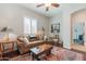 Cozy living room featuring a brown leather sofa and wooden coffee table at 18226 W Desert Willow Dr, Goodyear, AZ 85338