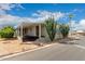 Mobile home with covered porch and desert landscaping at 11596 W Sierra Dawn Blvd # 157, Surprise, AZ 85378