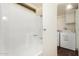 Bathroom with shower/tub combo and adjacent laundry area at 11596 W Sierra Dawn Blvd # 157, Surprise, AZ 85378