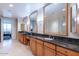 Double vanity bathroom with granite countertop and large mirrors at 2211 E Camelback Rd # 505, Phoenix, AZ 85016