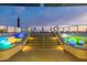 Steps lead to a rooftop deck with colorful lights and seating at 2211 E Camelback Rd # 505, Phoenix, AZ 85016