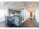 Modern kitchen with teal cabinets and breakfast bar at 2211 E Camelback Rd # 505, Phoenix, AZ 85016