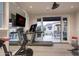 Home gym with Peloton bike, treadmill, and access to outdoor patio at 9848 E Parkside Ln, Scottsdale, AZ 85255